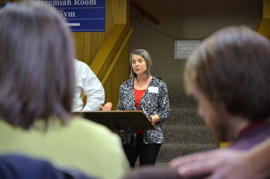 Emily Herriott speaks at a lectern in front of an audience